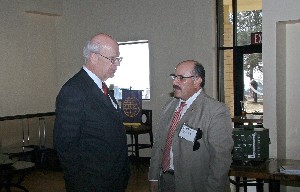 Schneider (l) talks with Benjamin Garcia, chapter vice president for small business, following the November luncheon.